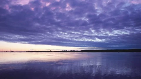 Sunrise at the river with vanilla clouds Stock Footage 130863332