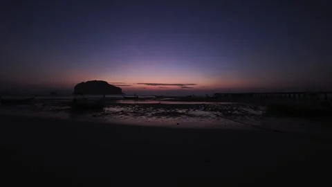 Sunrise on a sandy beach of a tropical island in Thailand with a pier  Stock Footage 332905751
