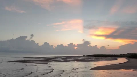 Sunrise as seabirds pass over the waters of Waingapu Stock Footage 272191233