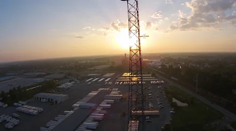 Sunrise seen through communications tower as camera ascends Stock Footage 49753341