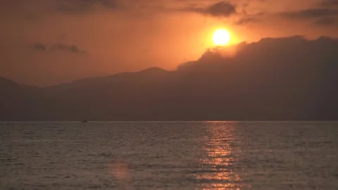 Sunrise on the Sevan lake against the backdrop of mountains and  sun, 4k Video stock 165726028