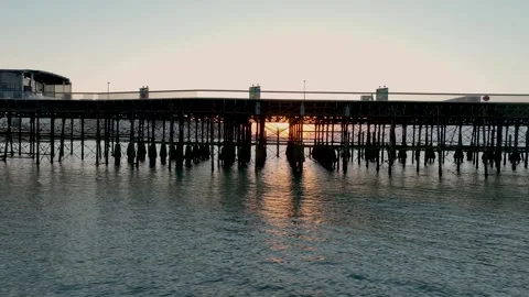 Sunrise shining through pier legs Stock Footage 345585224