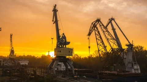 Sunrise at the shipyard  and clouds above the cranes. Stock Footage 86787312