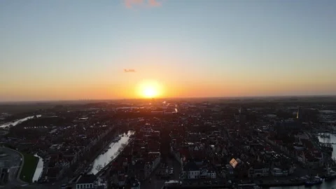 Sunrise silhouette pullback over Harlingen toward the sea Video stock 334104875