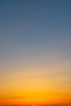 Sunrise sky with an orange-to-blue gradient Stock Photos