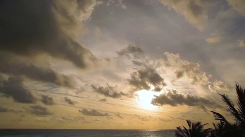 Sunrise sky with passing clouds over an ocean horizon Stock Footage 73822556