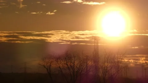 Sunrise sky, real time - 3/4 - power poles, wind turbines, trees, flying birds Stock Footage 151900944
