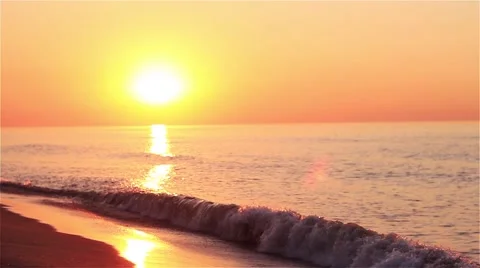 The sunrise with small wave on the sunny beach Stock Footage 54658359