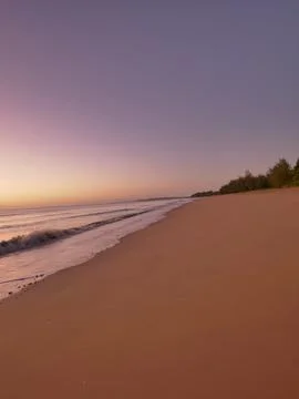 Sunrise on smooth beach Stock Photos