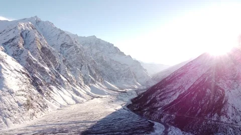 SUNRISE ON SNOW MOUNTAINS WITH FLARE Stock Footage 342091122
