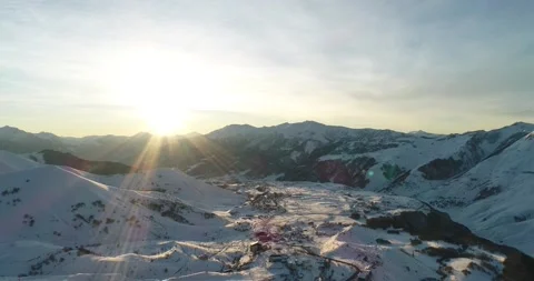 Sunrise from snowy cliff mountains in Gudauri ski resort. Caucasus mountains  Stock Footage