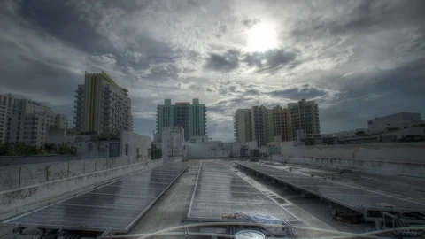 Sunrise, storms over solar panels, cityscape Stock Footage 125789099