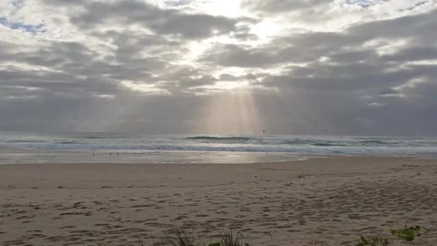 Sunrise Sun breaking through clouds over ocean sand dunes beach Australia Stock Footage 298447436