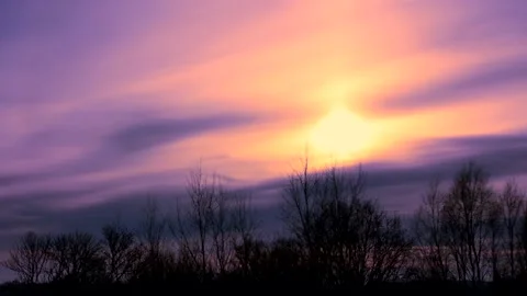 Sunrise sun over trees silhouettes - time lapse clouds - sky background - 24 fps Stock-Footage 147965705