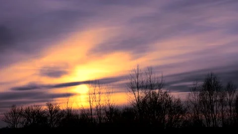 Sunrise sun over trees silhouettes - time lapse clouds - sky background - 25 fps Stock Footage 147967542
