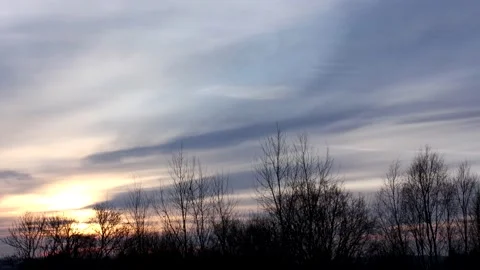 Sunrise sun over trees silhouettes - time lapse clouds - sky background - 60 fps Stock Footage 147972241