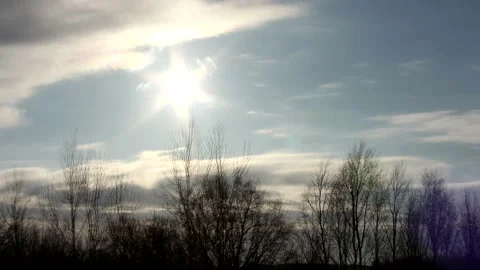 Sunrise sun over trees silhouettes - time lapse clouds - sky background - 24 fps Stock Footage 148192829