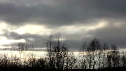 Sunrise sun over trees silhouettes - time lapse clouds - sky background - 25 fps Stock Footage 148193261