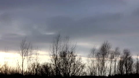 Sunrise sun over trees silhouettes - time lapse clouds - sky background - 30 fps Stock Footage 148193930