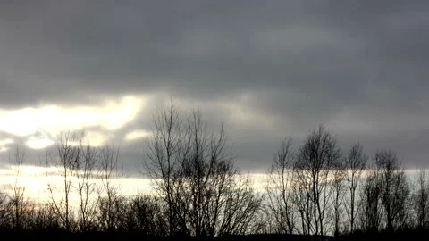 Sunrise sun over trees silhouettes - time lapse clouds - sky background - 50 fps Stock Footage 148196758