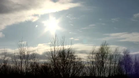 Sunrise sun over trees silhouettes - time lapse clouds - sky background - 50 fps Stock Footage 148196819