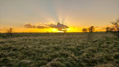 Sunrise with sunbeams Stock Photos