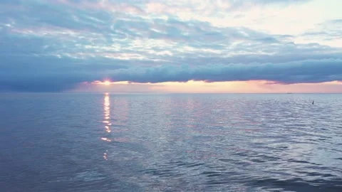 Sunrise, sunset with clouds dolly zoom, aerial shot of open sea , flying down Stock Footage 149242295