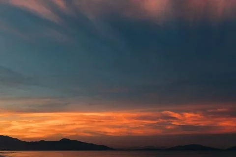 Sunrise, sunset of the sun through the clouds, tropical area near  sea. Stock Photos