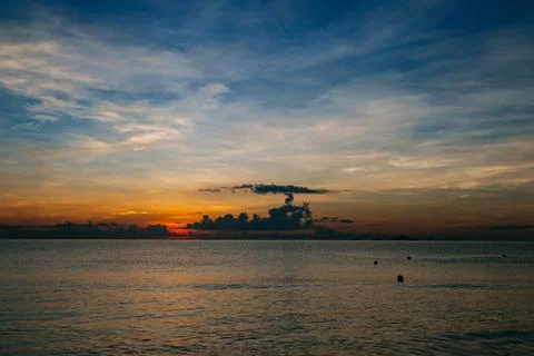 Sunrise, sunset of the sun through the clouds, tropical area near  sea. Stock Photos