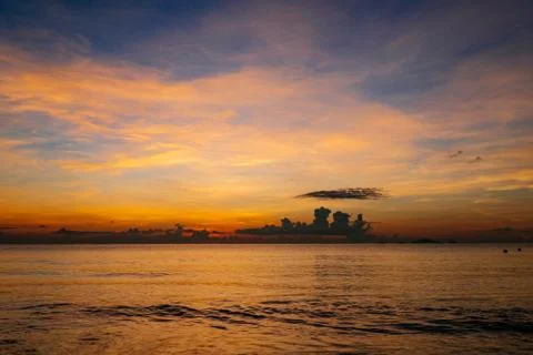 Sunrise, sunset of the sun through the clouds, tropical area near  sea. Stock Photos