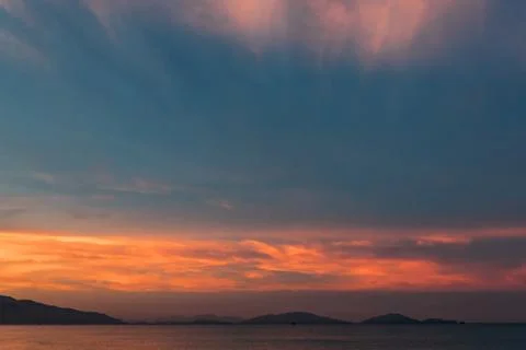 Sunrise, sunset of the sun through the clouds, tropical area near  sea. Stock Photos