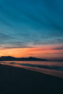 Sunrise, sunset of the sun through the clouds, tropical area near  sea. Stock Photos