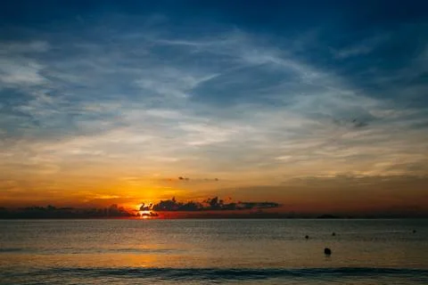 Sunrise, sunset of the sun through the clouds, tropical area near  sea. Stock Photos