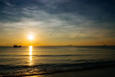Sunrise, sunset of the sun through the clouds, tropical area near  sea. Stock Photos