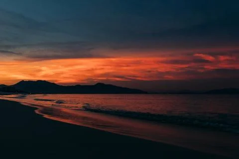 Sunrise, sunset of the sun through the clouds, tropical area near  sea. Stock Photos