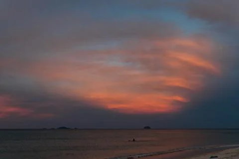 Sunrise, sunset of the sun through the clouds, tropical area near  sea. Stock Photos
