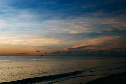 Sunrise, sunset of the sun through the clouds, tropical area near  sea Stock Photos