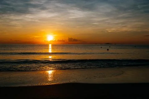 Sunrise, sunset of the sun through the clouds, tropical area near  sea Stock Photos