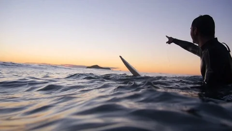 Sunrise surfing from underwater camera in New Zealand Stock Footage