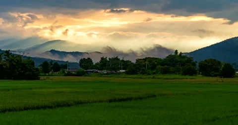 Sunrise through the clouds above the mountains with moving fog Stock Footage 288805027