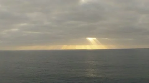 Sunrise through the clouds over the ocean time lapse HD Stock Footage 10809533