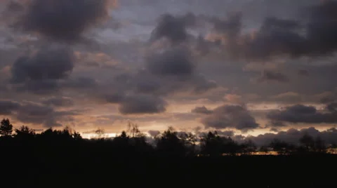 Sunrise through fast moving clouds  Видео 57933553