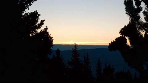Sunrise Through Trees In Mountains Stock Footage