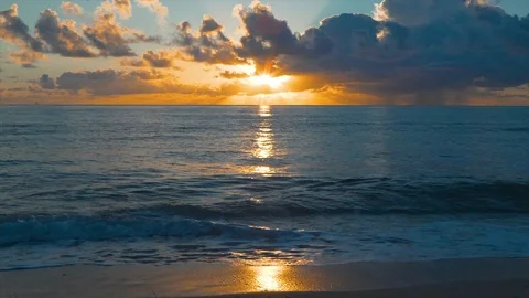 Sunrise throught the clouds on the ocean Stock Footage 98713549