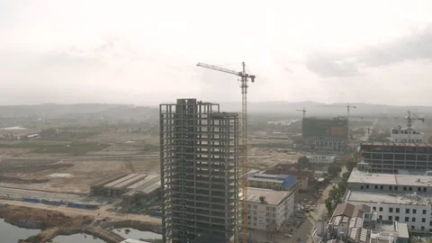 Sunrise time Construction Crane and building process 4K Drone shot Stock Footage 119367778