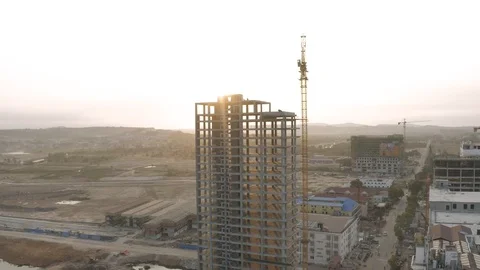 Sunrise time Construction Crane and building process 4K Drone shot Stock Footage 119368544