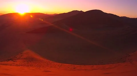 Sun rising over the red sand dunes of the Namib Desert, Namibia. Stock  Photo