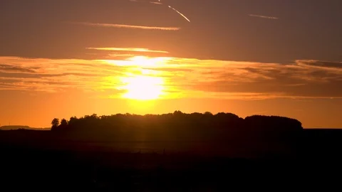 Sunrise time lapse over copse of trees in beautiful dawn Stock Footage 95805353