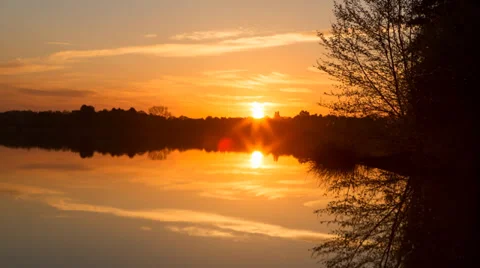 Sunrise time lapse over the still waters of a lake - 24FPS - 4k timelapse Stock Footage 37596792