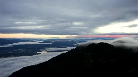 Sunrise Timelapse Above Rolling Clouds and Dark Alpine Mountain Peaks Video stock 345514295